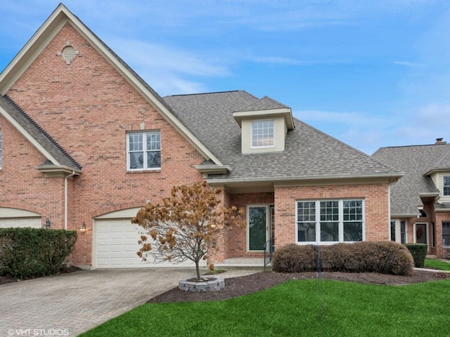 front of property featuring a front yard and a garage