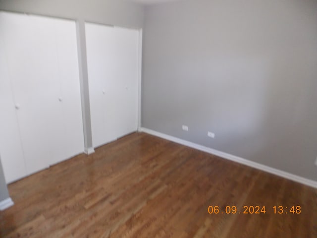 unfurnished bedroom with hardwood / wood-style floors