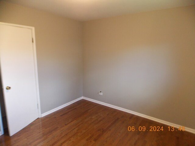 unfurnished room featuring dark hardwood / wood-style floors