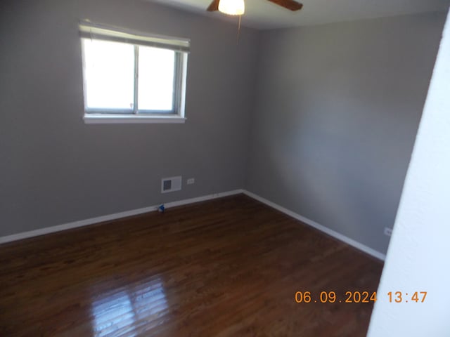 empty room with dark hardwood / wood-style floors and ceiling fan