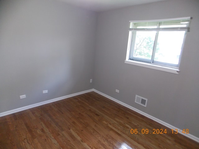 unfurnished room with dark hardwood / wood-style floors