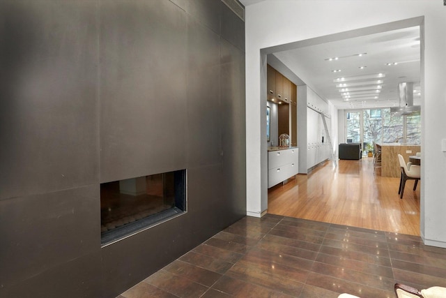 hall with dark tile patterned flooring