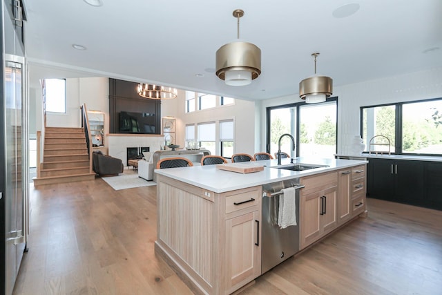 15W601 Grant St, Burr Ridge, IL 60527 - kitchen with dishwasher, light brown cabinets, an island with sink, and hanging light fixtures