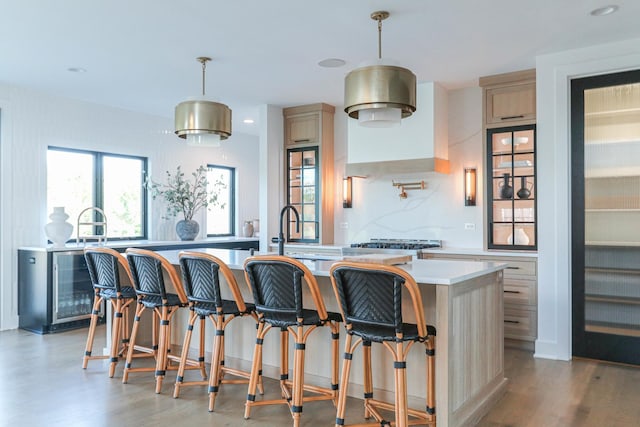 15W601 Grant St, Burr Ridge, IL 60527 - kitchen with a kitchen bar, a kitchen island with sink, sink, and decorative light fixtures