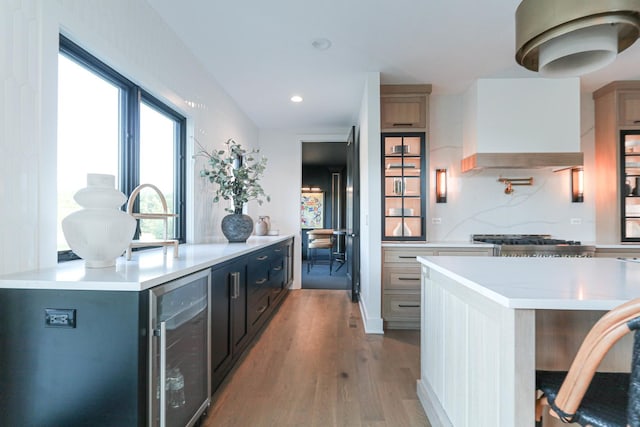 15W601 Grant St, Burr Ridge, IL 60527 - kitchen featuring a kitchen island, beverage cooler, custom range hood, and light wood-type flooring