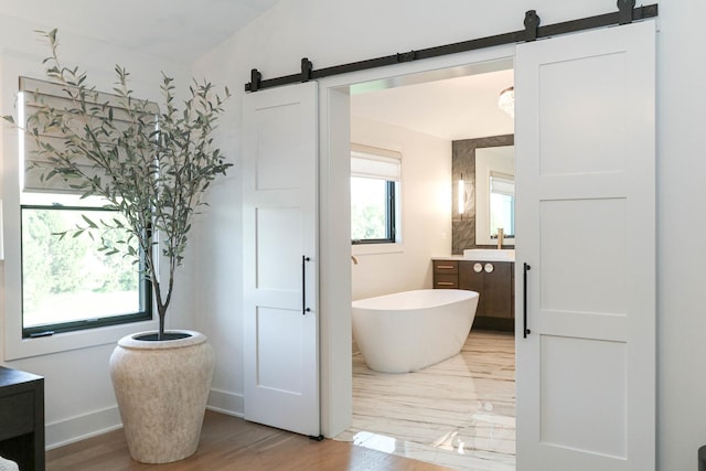 15W601 Grant St, Burr Ridge, IL 60527 - bathroom featuring a bath, vanity, hardwood / wood-style flooring, and lofted ceiling
