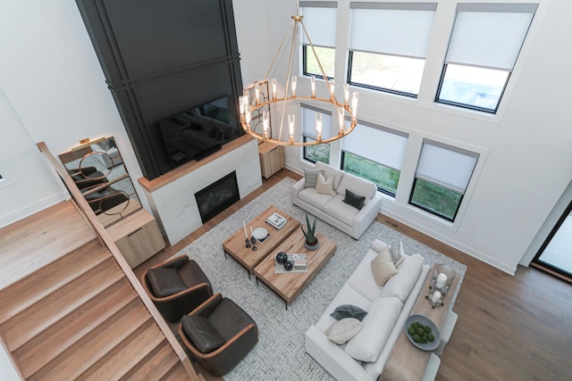 15W601 Grant St, Burr Ridge, IL 60527 - living room featuring hardwood / wood-style flooring, a notable chandelier, and a large fireplace