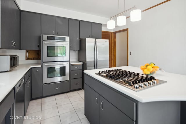 kitchen featuring a kitchen island, appliances with stainless steel finishes, light countertops, light tile patterned floors, and hanging light fixtures