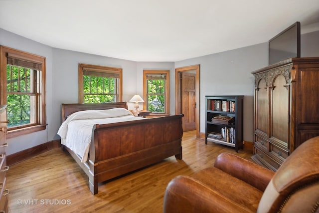 bedroom featuring light wood-style flooring and baseboards