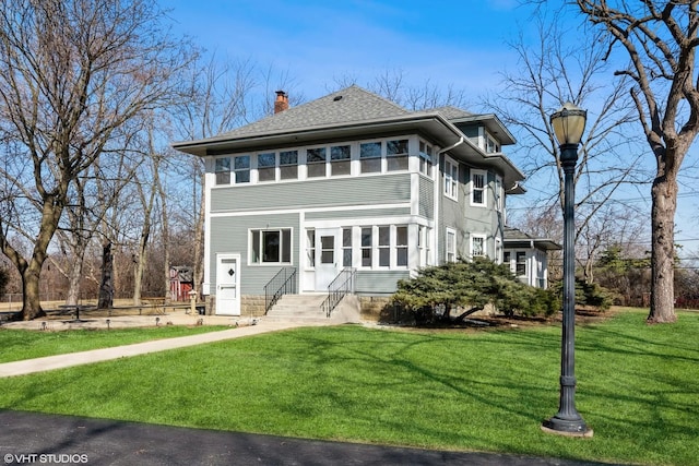 view of front of property featuring a front lawn, roof with shingles, and a chimney