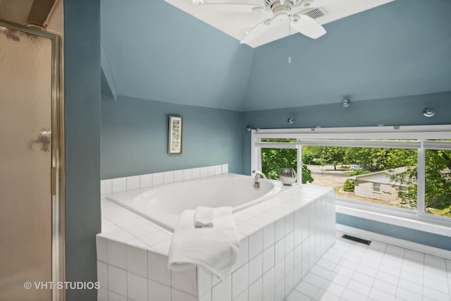 bathroom featuring lofted ceiling, a garden tub, visible vents, and tile patterned floors