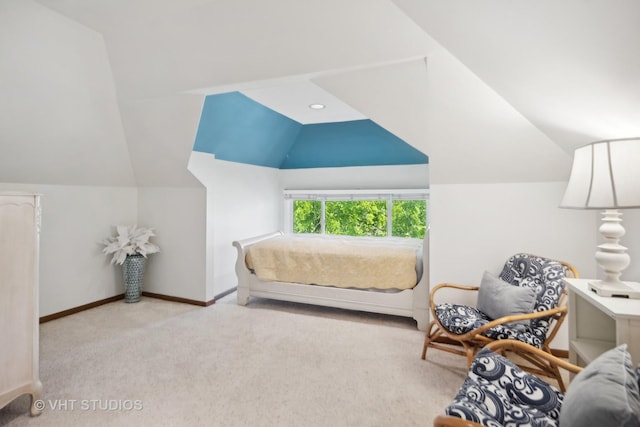 carpeted bedroom featuring baseboards and lofted ceiling