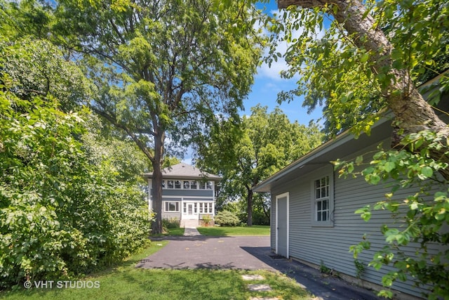 view of yard featuring a patio and driveway