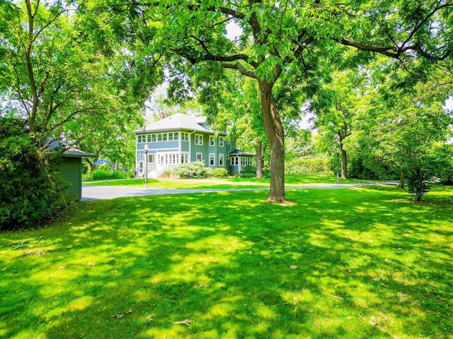 view of yard with a sunroom