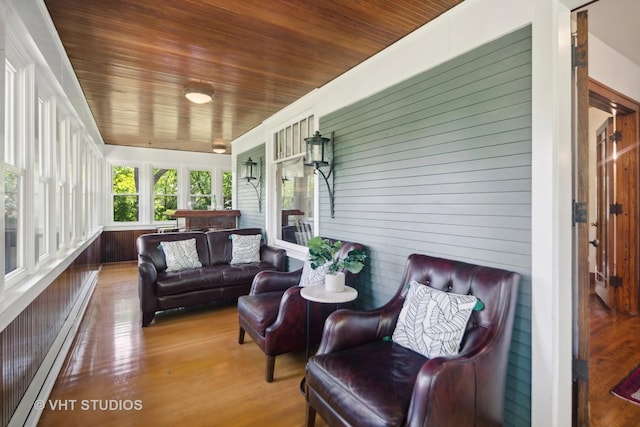 sunroom / solarium with wooden ceiling and a baseboard radiator