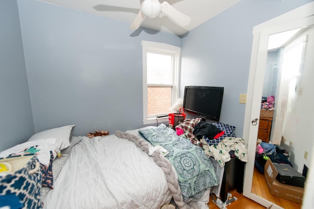 bedroom with ceiling fan and hardwood / wood-style floors