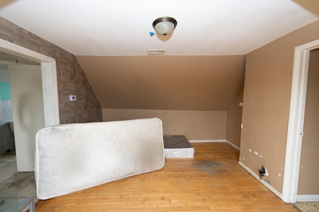 interior space featuring light hardwood / wood-style floors and lofted ceiling