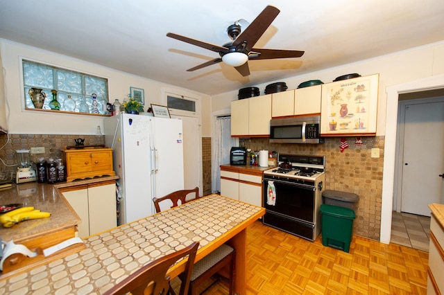 kitchen featuring white appliances, backsplash, tile counters, white cabinetry, and light parquet flooring