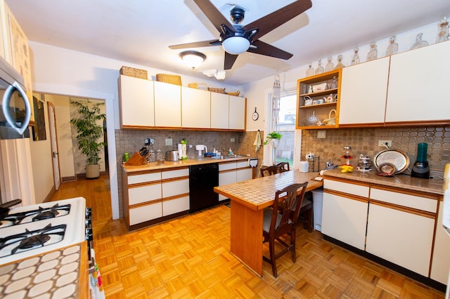 kitchen featuring ceiling fan, gas range gas stove, dishwasher, light parquet floors, and white cabinets