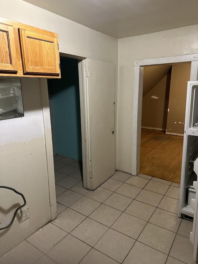 kitchen with light brown cabinets and light tile patterned floors