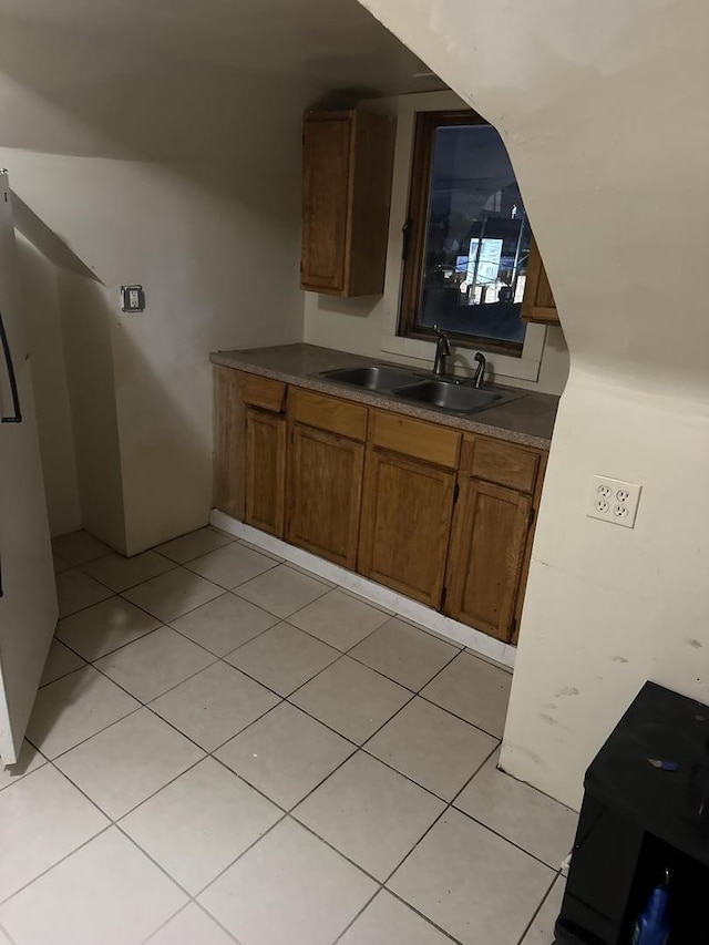 kitchen featuring sink and fridge