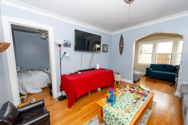 bedroom with hardwood / wood-style floors and crown molding