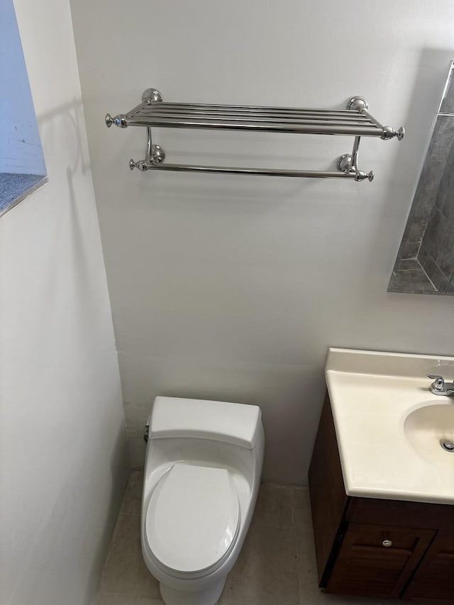 bathroom with tile patterned floors, vanity, and toilet