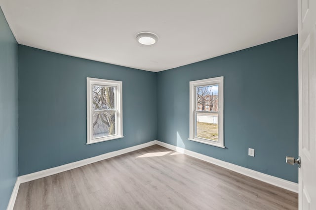 empty room with hardwood / wood-style flooring