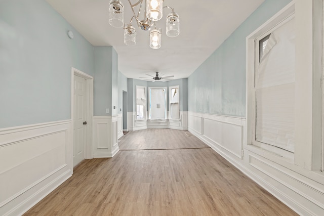 hallway featuring light hardwood / wood-style flooring and an inviting chandelier