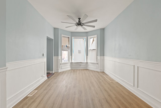 interior space with ceiling fan and light hardwood / wood-style floors