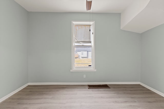 empty room featuring ceiling fan and hardwood / wood-style floors