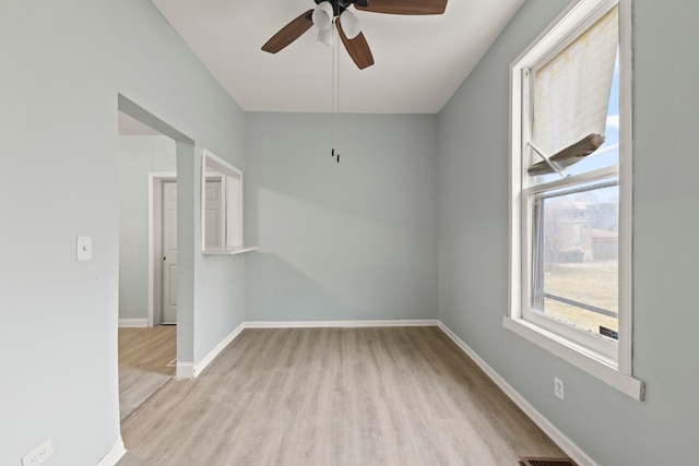 empty room featuring ceiling fan and light hardwood / wood-style flooring