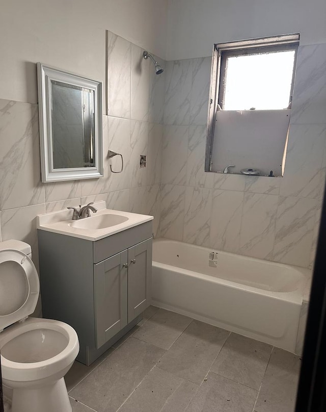 full bathroom featuring tiled shower / bath combo, tile patterned floors, toilet, vanity, and tile walls