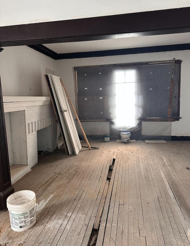 interior space with beamed ceiling and hardwood / wood-style flooring