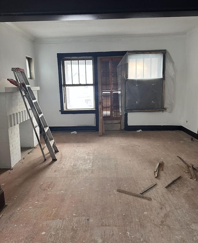 unfurnished living room with ornamental molding