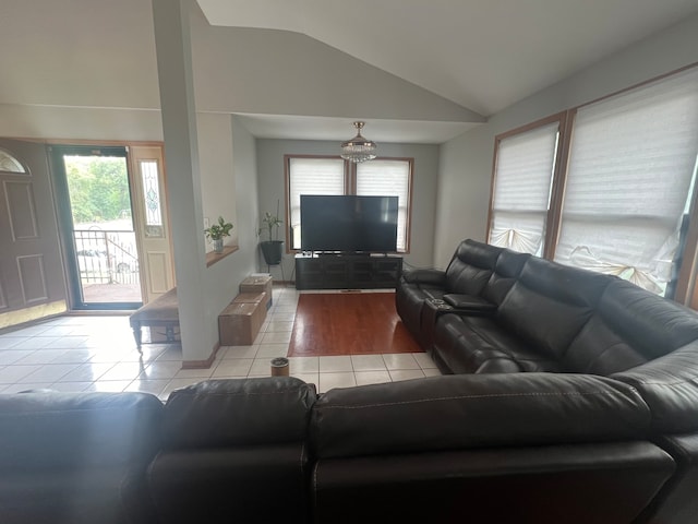 living room with light hardwood / wood-style flooring and vaulted ceiling