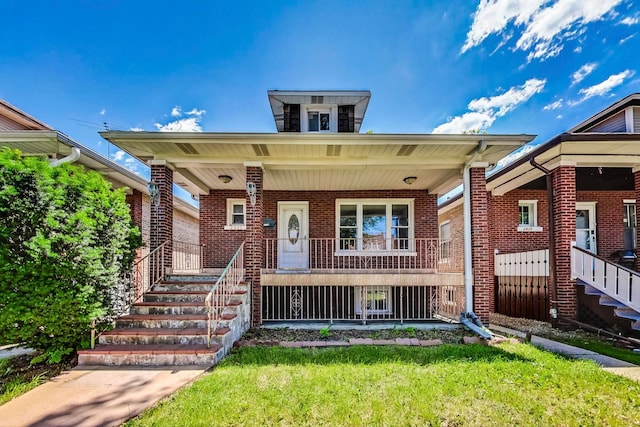 view of front of house with a front yard and a porch