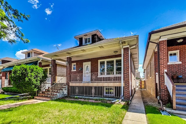 view of front of home with a porch and a front yard