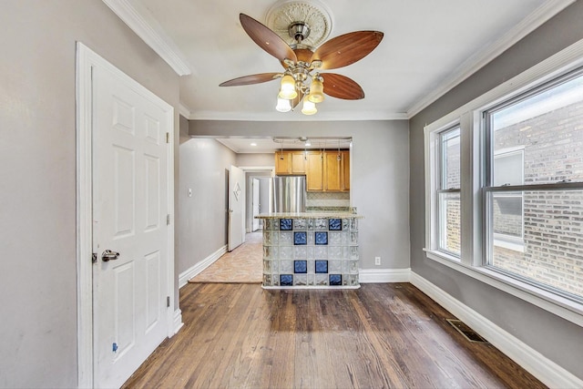 unfurnished living room featuring dark hardwood / wood-style floors, ceiling fan, and crown molding