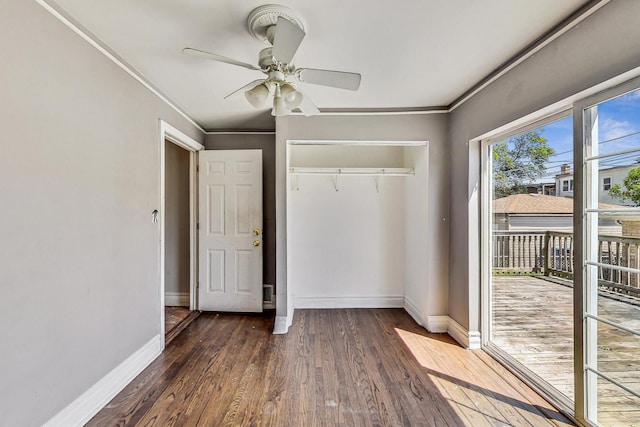 unfurnished bedroom with a closet, dark hardwood / wood-style floors, ceiling fan, and ornamental molding