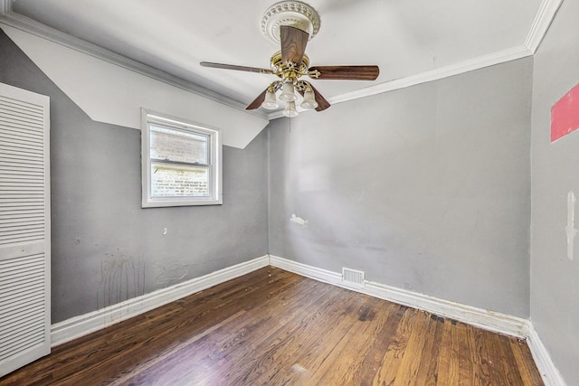 empty room featuring hardwood / wood-style flooring, ceiling fan, and ornamental molding