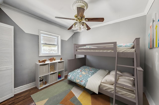 bedroom with ceiling fan, dark hardwood / wood-style flooring, and ornamental molding