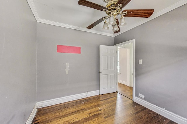 unfurnished room with crown molding, dark hardwood / wood-style flooring, and ceiling fan