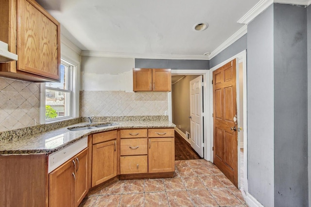 kitchen featuring tasteful backsplash, crown molding, sink, and light tile patterned floors