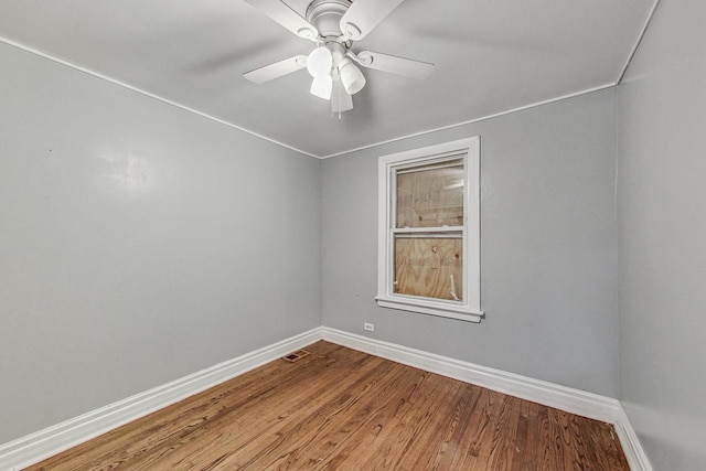 empty room with hardwood / wood-style floors and ceiling fan