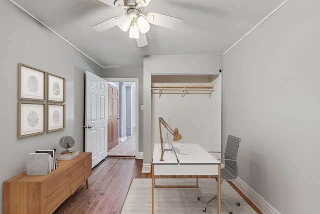 office with hardwood / wood-style flooring and ceiling fan