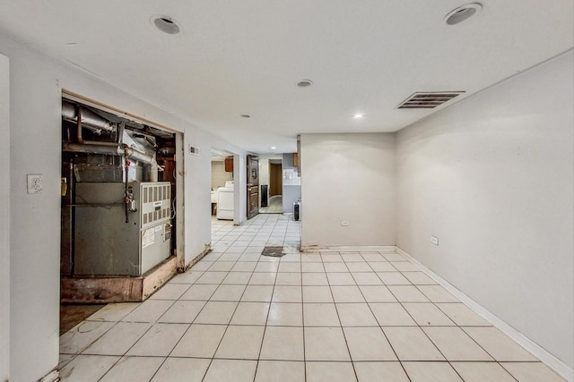 spare room featuring light tile patterned floors and washer / clothes dryer