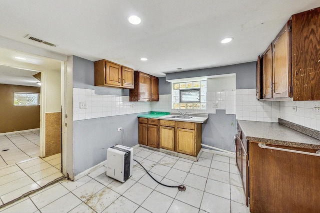 kitchen featuring plenty of natural light, light tile patterned floors, and sink