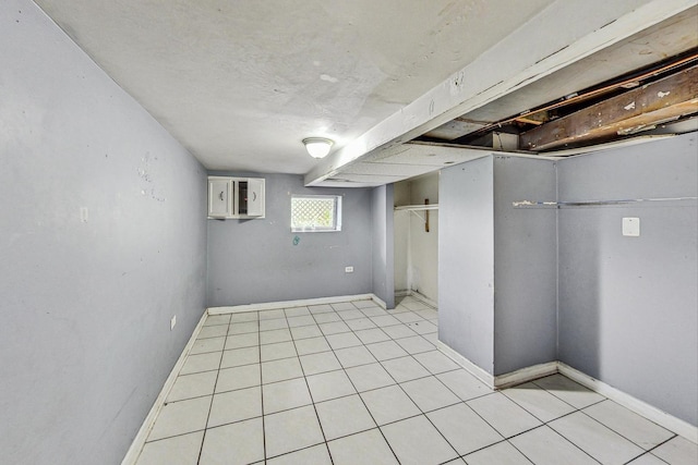 basement featuring light tile patterned floors