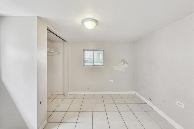 unfurnished bedroom featuring a closet and light tile patterned floors